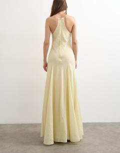 Model wearing Cut away racer neck full skirt maxi dress in buttermilk