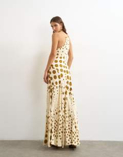 Model wearing Cut away racer neck full skirt maxi dress in taupe and chocolate polka dot