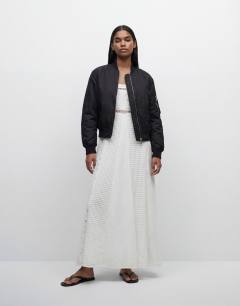 Model wearing Cutwork broderie mixed trapeze maxi dress in white