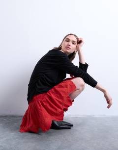 Model wearing Cutwork scalloped edge mini skirt in red