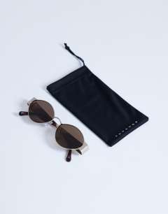 Model wearing Cyprus metal frame sunglasses in gold