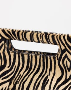 Model wearing Daniel medium hair on real leather rectangle grab bag in camel zebra