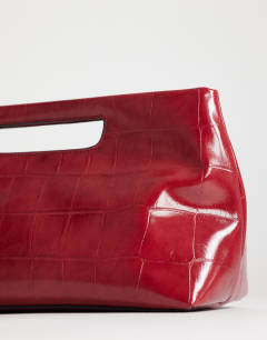 Model wearing Daniel medium rectangle grab bag in red croc