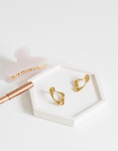 Model wearing Daphne waterproof stainless steel earrings in gold