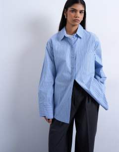 Model wearing Darted cuff oversized shirt in blue stripe