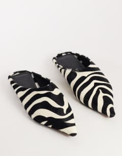 Model wearing Dawn flat pointed shoe in zebra print hair on real leather