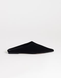 Model wearing Dawn real suede flat pointed shoe in black