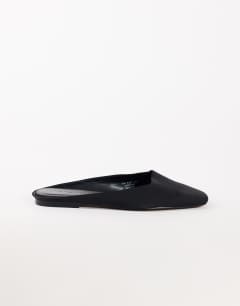 Model wearing Dawson slip on mule in black satin