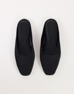 Model wearing Dawson slip on mule in black satin