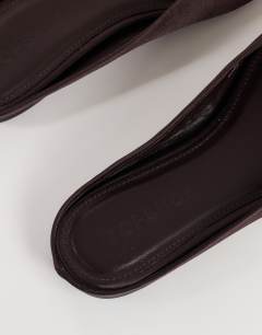 Model wearing Dawson slip on mule in chocolate satin