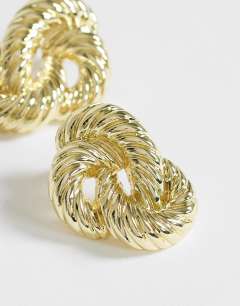 Model wearing Dean asymmetric hoop earring in gold