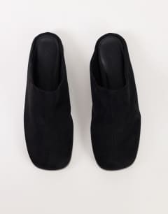 Model wearing Debbie faux suede square toe flat shoe mule in black