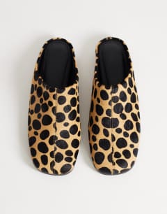 Model wearing Debbie square toe flat shoe mule in leopard print  hair on real leather