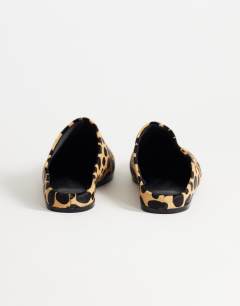 Model wearing Debbie square toe flat shoe mule in leopard print  hair on real leather