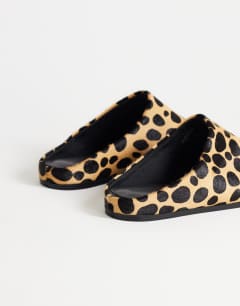 Model wearing Debbie square toe flat shoe mule in leopard print  hair on real leather