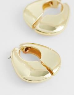 Model wearing Declan hoop earrings in gold