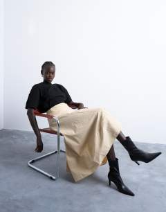 Model wearing Deep hem midi skirt in beige paper touch stripe