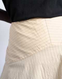 Model wearing Deep hem midi skirt in beige paper touch stripe