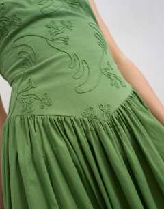 Model wearing Deep v back strappy midi sundress with cording in green