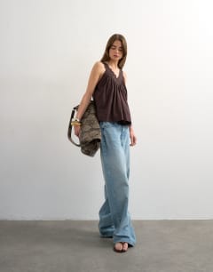 Model wearing Deep v lace trapeze top in chocolate