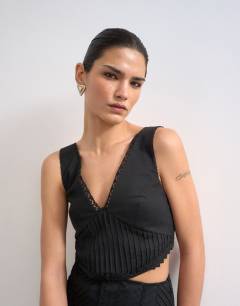 Model wearing Deep v maxi pinny dress with heavy embroidery in black