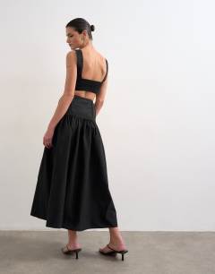 Model wearing Deep v maxi pinny dress with heavy embroidery in black