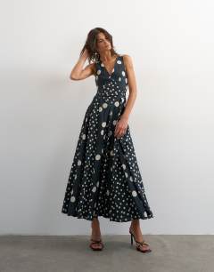 Model wearing Deep v neck maxi dress in navy polka dot