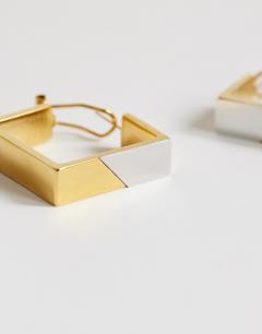Model wearing Delia waterproof stainless steel square hoop earring in gold with silver