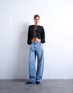 Model wearing Delicate tie front long sleeve top with lace in black