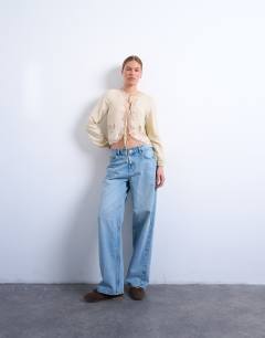 Model wearing Delicate tie front long sleeve top with lace in oyster