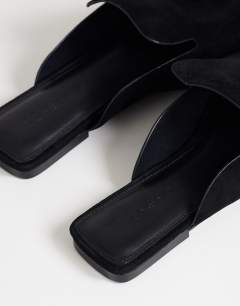 Model wearing Della real suede mule in black