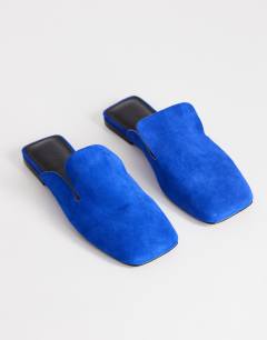Model wearing Della real suede mule in cobalt