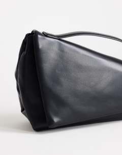 Model wearing Delta medium pyramid top handle grab bag in black