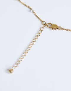 Model wearing Demi chain necklace with diamantes in stainless gold