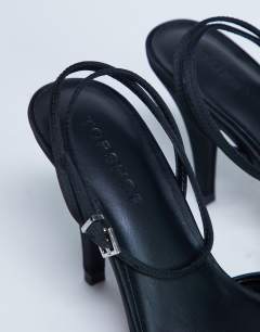 Model wearing Demi cone heel court shoe with tie in black