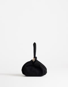 Model wearing Demi small suedette hardware wristlet grab bag in black