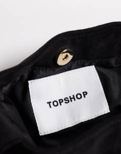 Model wearing Demi small suedette hardware wristlet grab bag in black