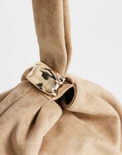 Model wearing Demi small suedette hardware wristlet grab bag in mink