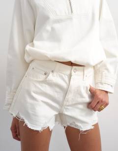 Model wearing Denim A-line short with rip in white
