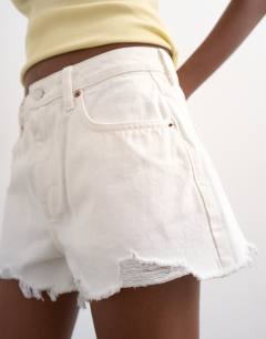 Model wearing Denim A-line shorts with rip in white