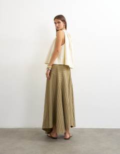 Model wearing Denim asymmetric drop waist maxi skirt in khaki stripe