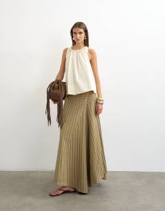 Model wearing Denim asymmetric drop waist maxi skirt in khaki stripe
