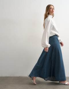 Model wearing Denim asymmetric dropped waist maxi skirt in blue grey