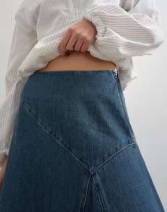 Model wearing Denim asymmetric dropped waist maxi skirt in blue grey
