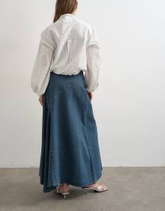 Model wearing Denim asymmetric dropped waist maxi skirt in blue grey