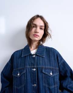 Model wearing Denim balloon sleeve jacket in indigo stripe