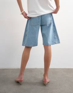 Model wearing Denim barrel jort in bleach stripe