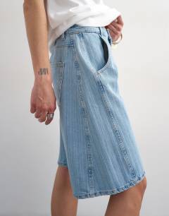 Model wearing Denim barrel jort in bleach stripe