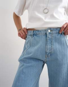 Model wearing Denim barrel jort in bleach stripe