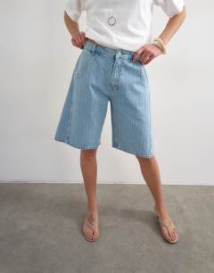 Model wearing Denim barrel jort in bleach stripe
